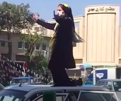 Screenshot from a User Generated Content video of a woman dancing on a car roof in Tehran_2021. — © In Field Journal 21, Spring 2022.